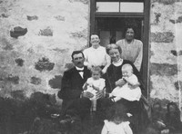 A Family At The Door Of Their House