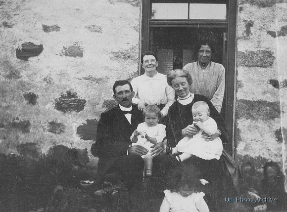A Family At The Door Of Their House
