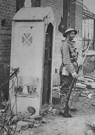 A British Soldier Standing In A German Sentry Box after The Enemy Had Fallen Back During The Advance On Bapaume And Peronne
