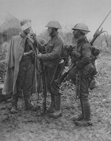 A British Soldiers Giving A Wounded German A Cigarette