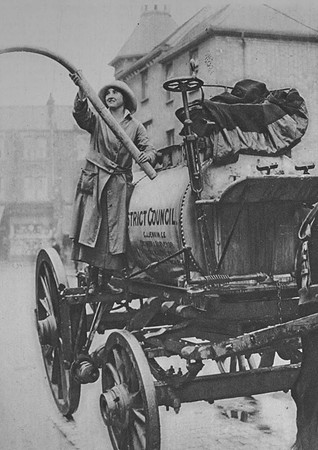 A Woman Working A Watering Cart In Finchley London