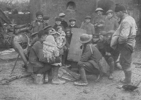 French Children Sitting Round A Camp Fire Wih British Soldiers In A Recaptured Village