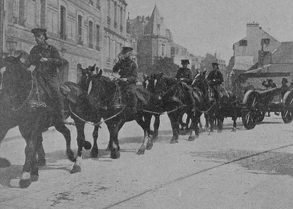 British Heavy Artillery Leaving A Base Town