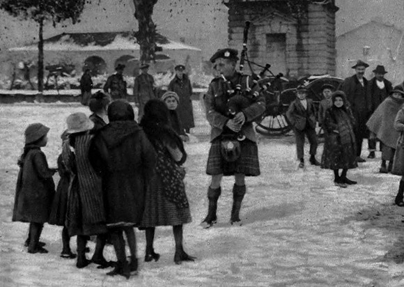 Children Watcing A Highland Pipe Player In Northern Italy
