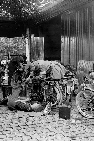 A Dispatch Rider Repairing A Motor Cycle Merville France