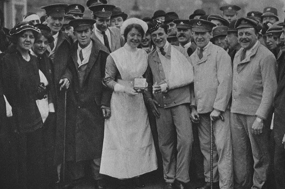 A Group Of Wounded Soldiers With Their Nurse Collecting A Red Cross Award