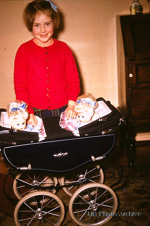 Playing With A Christmas Pram And Dolls