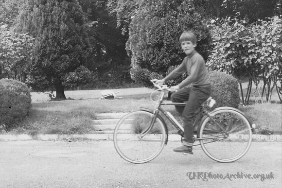 A Boy Cycling In The 1960s