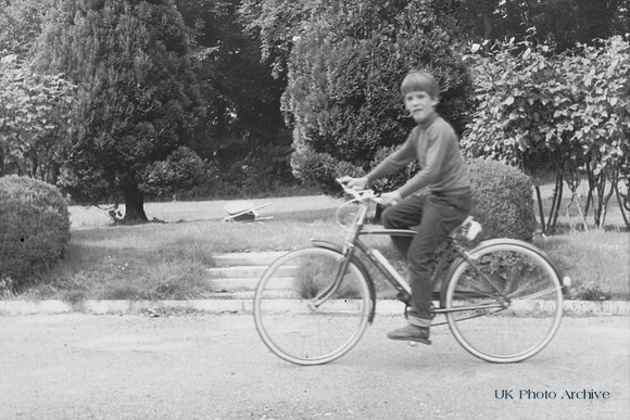 A Boy Cycling In The 1960s