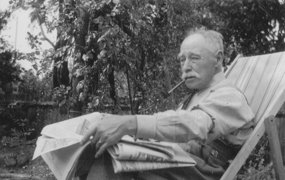 An Old Man With A Pipe Reading A Newspaper 1950s