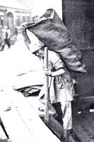 A Woman Gas Worker Carrying A Hundredweight Sack Of Coke