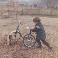 A Little Boy With His Tricycle