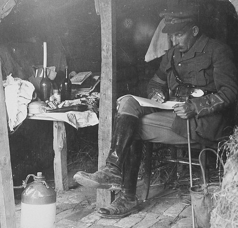 Staff Officer From CHQ In Dug Out Studying Details Before Offensive
