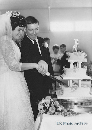 Bride And Groom Cutting Wedding Cake 1960s
