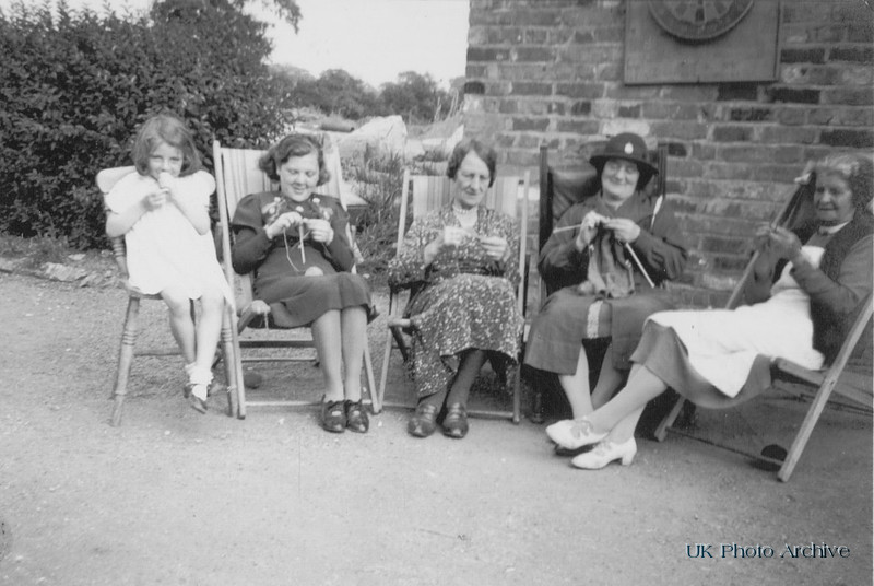 Sheila Roe and Fanny Roe knitiing With Family