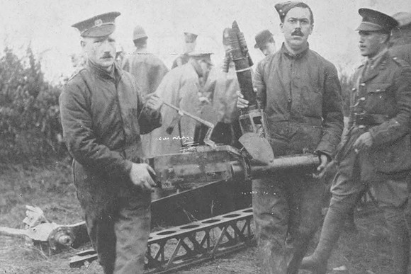 Soldiers Removing A Machine Gun From The Wreckage