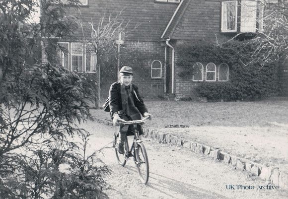 A Little Boy Cycling To School 1950s