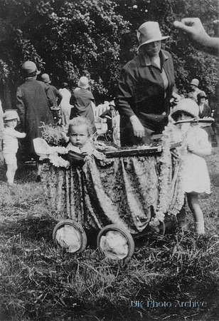 A Family And Baby In A Decorated Pram