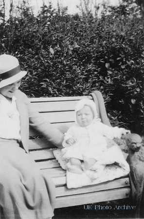 A Mother With A Baby Sitting On A Bench