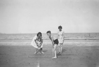 A Family Playing Cricket On The Beach 1940s