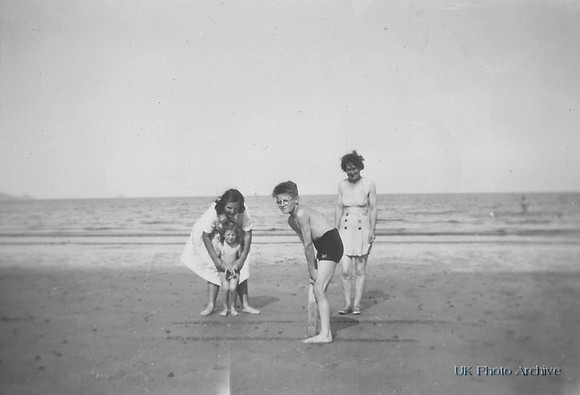 A Family Playing Cricket On The Beach 1940s
