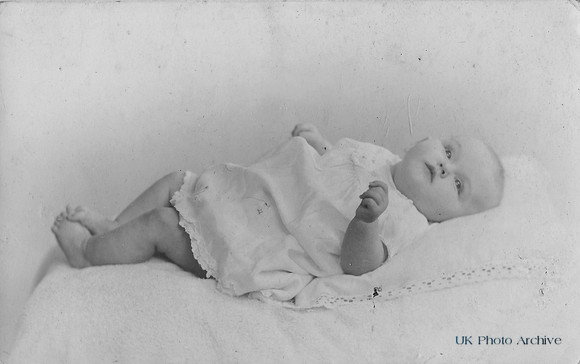 A Cute Baby In A Lacy Dress