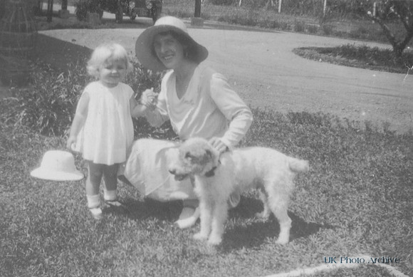 A Woman With A Little Girl And A Dog