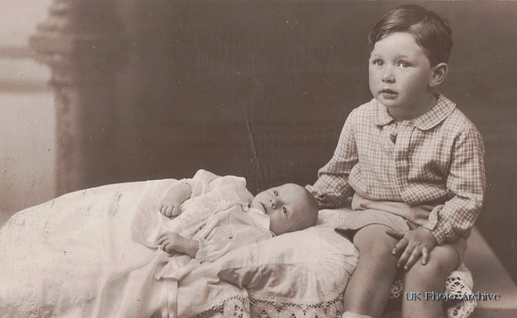 A Young Boy With A Baby