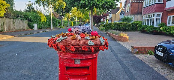 A Post Box Knitted Topper In Sutton Surrey
