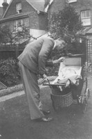 Man Looking At Baby In Pram 1930s