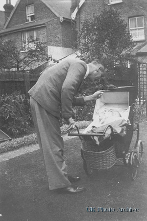 Man Looking At Baby In Pram 1930s
